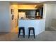 Open-concept kitchen with a breakfast bar, seating, and modern appliances at 5855 Valley Dr # 2092, North Las Vegas, NV 89031