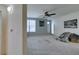 A lovely living room showing neutral paint, a ceiling fan, a large window, and carpeting at 5855 Valley Dr # 2092, North Las Vegas, NV 89031