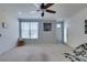 Bright living room with a ceiling fan, neutral-colored walls, large window, and plush carpeting throughout at 5855 Valley Dr # 2092, North Las Vegas, NV 89031