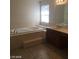 Bathroom with a tub, tile flooring and a vanity at 6245 Hawthorn Woods Ave, Las Vegas, NV 89130