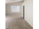 Bedroom with carpeted floor, a window, and an open doorway at 6245 Hawthorn Woods Ave, Las Vegas, NV 89130