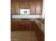 Kitchen featuring granite countertops, stainless steel appliances, tile floors, and wooden cabinets at 6245 Hawthorn Woods Ave, Las Vegas, NV 89130