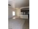 Open concept living room flowing into a kitchen with stainless steel appliances at 6245 Hawthorn Woods Ave, Las Vegas, NV 89130
