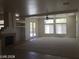 Spacious living room featuring fireplace, carpet, tile, and large windows for natural light at 6245 Hawthorn Woods Ave, Las Vegas, NV 89130