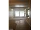Bright living room with carpet, tile, large window for natural light, and staircase accent at 6245 Hawthorn Woods Ave, Las Vegas, NV 89130