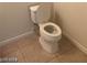 Close-up of a toilet in a bathroom with tiled flooring at 6245 Hawthorn Woods Ave, Las Vegas, NV 89130