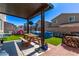 Backyard features a covered patio, wood burning pit, picnic table and above ground pool at 6313 Voss St, North Las Vegas, NV 89081