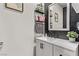 Stylish powder room features black accent wall, floating shelves, and white vanity at 6313 Voss St, North Las Vegas, NV 89081