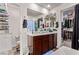 Bathroom featuring double sinks, large mirror, and walk-in closet at 6313 Voss St, North Las Vegas, NV 89081