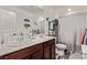 Bright bathroom features a double sink vanity, and a shower-tub combination at 6313 Voss St, North Las Vegas, NV 89081