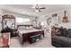 Spacious bedroom with ceiling fan, guitar wall decor, and comfortable seating at 6313 Voss St, North Las Vegas, NV 89081