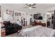 Bedroom with dark couch, mini refrigerator, and large TV at 6313 Voss St, North Las Vegas, NV 89081