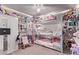 Shared bedroom with a triple bunk bed setup, bookshelves, and colorful decor creating a shared space at 6313 Voss St, North Las Vegas, NV 89081