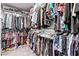Walk-in closet with an array of clothing on hangers and shelves at 6313 Voss St, North Las Vegas, NV 89081