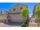 Charming house with a two-car garage, complemented by a brick driveway and a well-manicured front yard at 6313 Voss St, North Las Vegas, NV 89081