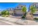 Beautiful house with a two-car garage, a brick driveway, and mature trees enhancing the curb appeal at 6313 Voss St, North Las Vegas, NV 89081