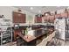 Modern kitchen with dark granite countertops, stainless steel appliances, and center island with seating at 6313 Voss St, North Las Vegas, NV 89081