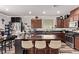Open concept kitchen with seating at the center island and view to dining area and backyard at 6313 Voss St, North Las Vegas, NV 89081