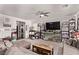 Comfortable living room features neutral tones, a ceiling fan, and shelving units for optimal storage at 6313 Voss St, North Las Vegas, NV 89081