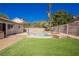 Fenced backyard featuring a pristine pool, patio area, lush green grass, and mature landscaping at 6330 Spring Meadow Dr, Las Vegas, NV 89103