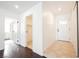 Inviting hallway featuring dark wood flooring and modern tiled flooring leading to various rooms in the home at 6330 Spring Meadow Dr, Las Vegas, NV 89103