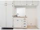 Bright, white kitchen area with modern fixtures and granite countertops at 6330 Spring Meadow Dr, Las Vegas, NV 89103