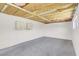 Unfinished basement with painted concrete walls, flooring and exposed ceiling at 636 Burton St, Henderson, NV 89015