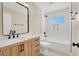 Bathroom featuring a vanity with black hardware, white tile, and a bathtub/shower combo at 636 Burton St, Henderson, NV 89015