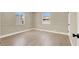 Empty bedroom featuring wood laminate flooring, neutral colored walls, and a window at 636 Burton St, Henderson, NV 89015