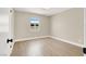 Bedroom featuring modern laminate flooring, neutral walls, and a bright window at 636 Burton St, Henderson, NV 89015