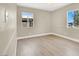 Bedroom featuring neutral walls, laminate flooring, and a window with a view at 636 Burton St, Henderson, NV 89015