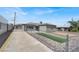 View of driveway leading to home featuring xeriscaping, fenced yard, and neutral paint at 636 Burton St, Henderson, NV 89015