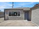Home's front entrance with modern paint, a large window, and a charming blue door at 636 Burton St, Henderson, NV 89015