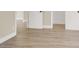 Hallway with laminate flooring, white baseboards, and doors at 636 Burton St, Henderson, NV 89015