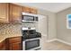 The kitchen has stainless steel appliances, wooden cabinets, and a view of the adjacent room at 636 Burton St, Henderson, NV 89015