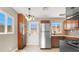 Eat-in kitchen boasts stainless steel appliances, wood cabinets, and natural light at 636 Burton St, Henderson, NV 89015