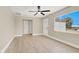 Bright living room with hardwood floors, neutral walls, ceiling fan, and natural light at 636 Burton St, Henderson, NV 89015