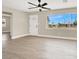 Bright living room with laminate flooring, a large window, and a white front door at 636 Burton St, Henderson, NV 89015