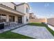 Large backyard with an extended covered patio, lush lawn, and barbecue setup at 6486 Vanhoven Crest St, Las Vegas, NV 89166