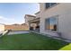 Spacious backyard with a well-maintained lawn, patio, and barbecue area at 6486 Vanhoven Crest St, Las Vegas, NV 89166