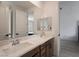 Bathroom features a double sink vanity, large mirrors, and a view into the bedroom at 6486 Vanhoven Crest St, Las Vegas, NV 89166