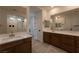 Bright bathroom with dual vanities, quartz countertops and a glass shower at 6486 Vanhoven Crest St, Las Vegas, NV 89166