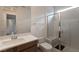 Inviting bathroom featuring a glass enclosed shower, granite countertops and under sink cabinets at 6486 Vanhoven Crest St, Las Vegas, NV 89166
