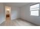 Clean and bright bedroom with hardwood floors, neutral walls and view to the ensuite bath at 6486 Vanhoven Crest St, Las Vegas, NV 89166