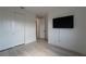 Comfortable bedroom with plank floors, a double closet and a tv at 6486 Vanhoven Crest St, Las Vegas, NV 89166