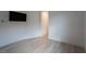 Neat bedroom featuring wood floors, a window, and a view to the hall at 6486 Vanhoven Crest St, Las Vegas, NV 89166
