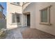 Inviting front entrance with paver walkway, desert landscaping, a black front door, and modern window trim at 6486 Vanhoven Crest St, Las Vegas, NV 89166