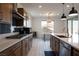Gourmet kitchen with stainless steel appliances, center island with barstool seating, and modern backsplash at 6486 Vanhoven Crest St, Las Vegas, NV 89166