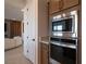 Kitchen view showcasing stainless steel appliances and adjacent living area at 6486 Vanhoven Crest St, Las Vegas, NV 89166