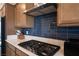 Close-up of the kitchen featuring modern appliances and stylish blue backsplash at 6486 Vanhoven Crest St, Las Vegas, NV 89166